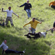 Contestants in the men’s race chase a Double Gloucester Cheese down the steep gradient of Cooper’s Hill during the annual Bank Holiday tradition of cheese-rolling in 2013.